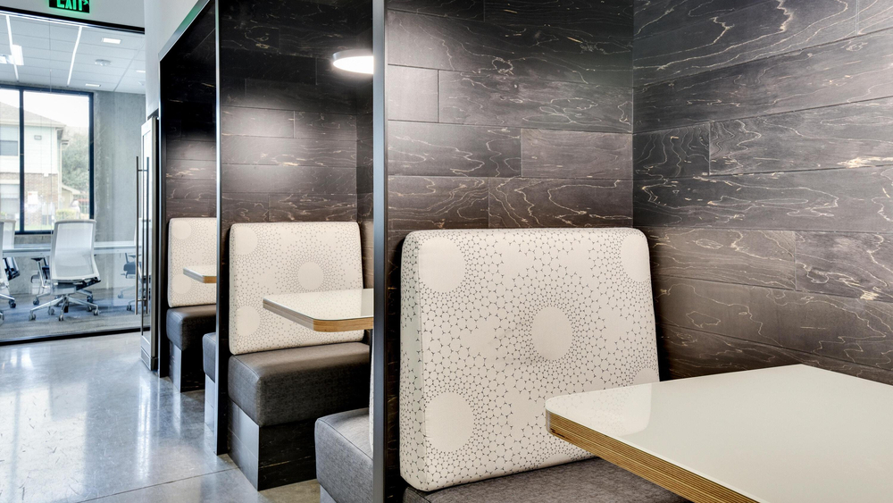 Red River’s design team used engineered hardwood wall cladding to offset the black, white and gray palette in this meeting space.